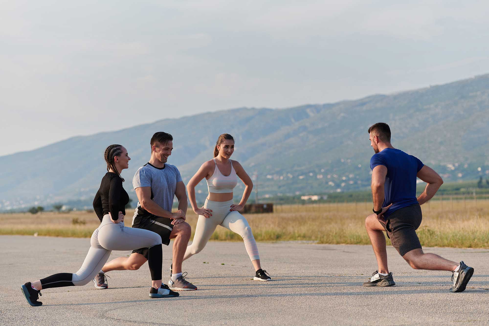 Group training session performing endurance exercises outdoors.